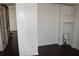 Bedroom showcases an open closet and white trim, featuring dark hardwood floors throughout at 821 Silver Springs Nw Ter, Port Charlotte, FL 33948