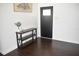 Foyer featuring hardwood floors, neutral walls, and a console table, creating a welcoming entrance at 821 Silver Springs Nw Ter, Port Charlotte, FL 33948