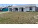 Inviting home with arched porch, black trim, and a drought resistant front yard at 821 Silver Springs Nw Ter, Port Charlotte, FL 33948