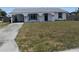 Charming home with an arched porch, black trim, and a drought resistant front yard at 821 Silver Springs Nw Ter, Port Charlotte, FL 33948