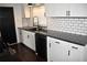 Updated kitchen featuring white cabinets, granite counters, subway tile and modern appliances at 821 Silver Springs Nw Ter, Port Charlotte, FL 33948
