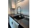The kitchen features granite countertops, white cabinetry, and a modern black faucet at 821 Silver Springs Nw Ter, Port Charlotte, FL 33948