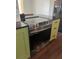 Stainless steel oven with a glass stovetop, built into custom cabinets and granite countertops at 821 Silver Springs Nw Ter, Port Charlotte, FL 33948