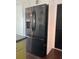 Modern black stainless steel refrigerator, blending seamlessly with updated kitchen design elements at 821 Silver Springs Nw Ter, Port Charlotte, FL 33948