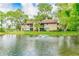 Picturesque two-story condo overlooking a tranquil pond with a fountain and mature trees at 870 Village Lake N Ter # 204, St Petersburg, FL 33716