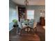 Light-filled dining room with wood floors, modern lighting, and four-seat glass table at 9790 66Th N St # 100, Pinellas Park, FL 33782