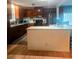 Spacious kitchen with a center island, granite countertops, dark wood cabinets, and stainless appliances at 9790 66Th N St # 100, Pinellas Park, FL 33782