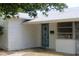 Bright blue front door with white brick exterior and awning at 2580 68Th S Ave, St Petersburg, FL 33712