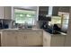 Well lit kitchen with stainless steel appliances and white cabinets at 2580 68Th S Ave, St Petersburg, FL 33712