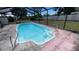 Screened in pool with clear blue water and built in steps with metal hand rails in an outdoor setting at 2580 68Th S Ave, St Petersburg, FL 33712