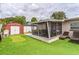 Backyard featuring a covered porch, shed and mini putting green on artificial turf at 5710 92Nd N Ter, Pinellas Park, FL 33782