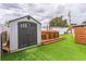 Backyard featuring a shed, hot tub on a wooden deck, and artificial turf at 5710 92Nd N Ter, Pinellas Park, FL 33782