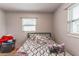 Bedroom features neutral walls, a window and black metal bed frame with patterned bedding at 5710 92Nd N Ter, Pinellas Park, FL 33782