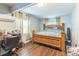 Bedroom features wood floors, curtains, and natural light from multiple windows at 5710 92Nd N Ter, Pinellas Park, FL 33782