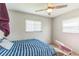 This bedroom has two windows, neutral walls and a blue stripped bed at 5710 92Nd N Ter, Pinellas Park, FL 33782