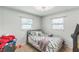 Cozy bedroom with carpet, ceiling fan, window and a black metal bedframe at 5710 92Nd N Ter, Pinellas Park, FL 33782