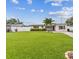 Inviting single-story home featuring a lush green lawn, vibrant plants, and a welcoming front entrance at 5710 92Nd N Ter, Pinellas Park, FL 33782