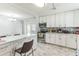 Bright kitchen features white cabinetry, island with marble countertop, stainless steel appliances and marble flooring at 5710 92Nd N Ter, Pinellas Park, FL 33782