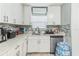 Bright kitchen with white cabinets, marble countertops, and stainless steel appliances at 5710 92Nd N Ter, Pinellas Park, FL 33782