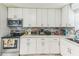 Kitchen featuring white cabinets, stainless steel appliances, and modern countertops at 5710 92Nd N Ter, Pinellas Park, FL 33782
