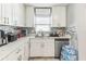 Bright kitchen with white cabinets, marble countertops, and stainless steel appliances at 5710 92Nd N Ter, Pinellas Park, FL 33782