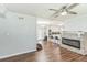 Spacious living room boasts a stone fireplace, wood floors and views of kitchen at 5710 92Nd N Ter, Pinellas Park, FL 33782