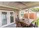 Covered patio featuring a dining table set and access to the backyard at 5710 92Nd N Ter, Pinellas Park, FL 33782