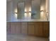 Elegant bathroom showcasing double sinks, decorative mirrors, stylish lighting and tile backsplash at 608 Bittner Blvd, Nokomis, FL 34275