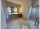 Modern bathroom with double sinks, decorative mirrors and an elegant glass enclosed shower at 608 Bittner Blvd, Nokomis, FL 34275