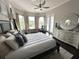 Inviting bedroom featuring bay windows, seating area, ceiling fan and hardwood floors at 608 Bittner Blvd, Nokomis, FL 34275