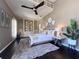 Charming bedroom featuring built-in shelving, ceiling fan, dark wood floors and neutral decor at 608 Bittner Blvd, Nokomis, FL 34275