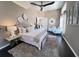 Cozy bedroom featuring neutral color palette, dark hardwood floors, ceiling fan and decorative wall art at 608 Bittner Blvd, Nokomis, FL 34275