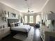 Bright bedroom offering bay windows, ceiling fan, wood floors and seating area at 608 Bittner Blvd, Nokomis, FL 34275