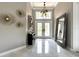 Welcoming entryway with a high ceiling, large mirror, decorative lighting, and tile flooring at 608 Bittner Blvd, Nokomis, FL 34275