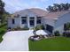 Stunning home features a well-manicured lawn, beautiful landscaping, and a spacious driveway at 608 Bittner Blvd, Nokomis, FL 34275