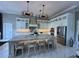 Well-equipped kitchen features a central island, pendant lighting, custom cabinets, and stainless-steel appliances at 608 Bittner Blvd, Nokomis, FL 34275