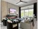 Modern living room features a fireplace, large windows with scenic views, and stylish furnishings at 608 Bittner Blvd, Nokomis, FL 34275