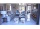 Cozy living room with modern furniture, a decorative fireplace, and an open floor plan at 608 Bittner Blvd, Nokomis, FL 34275