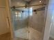 Contemporary bathroom shower featuring glass enclosure, mosaic accent tile, and a pebble tile floor at 608 Bittner Blvd, Nokomis, FL 34275