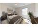 Bedroom with a queen bed, window for natural light, and neutral decor at 14673 Italy Ave, Dade City, FL 33523