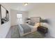 Bedroom featuring a queen bed, modern decor, and a view from the window at 14673 Italy Ave, Dade City, FL 33523