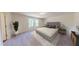 Bright bedroom with a queen bed, neutral decor, and natural lighting from the window at 14673 Italy Ave, Dade City, FL 33523
