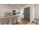 Bright kitchen boasts white cabinets, stainless steel appliances, and granite countertops with an island at 14673 Italy Ave, Dade City, FL 33523