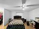 Bedroom with laminate floors, ceiling fan, and small window for natural light at 2008 Mandalay Ct, Oldsmar, FL 34677