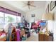 Bedroom currently used for storage with a ceiling fan, large windows and generous natural light at 232 Countryside Key Blvd, Oldsmar, FL 34677