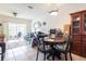Dining room showcases a round table with a china cabinet, and sliding glass doors to screened in porch at 232 Countryside Key Blvd, Oldsmar, FL 34677