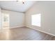 Bright bedroom with vaulted ceilings, wood-look floors, and a large window offering natural light at 24237 Rolling View Ct, Lutz, FL 33559