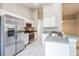 Bright kitchen with stainless-steel appliances, white cabinets and tiled floor at 24237 Rolling View Ct, Lutz, FL 33559