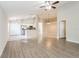 Open-concept living room with tile and wood-look flooring and access to the kitchen at 24237 Rolling View Ct, Lutz, FL 33559
