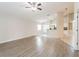 Open-concept living room showcasing wood-look floors, neutral walls and seamless access to kitchen at 24237 Rolling View Ct, Lutz, FL 33559